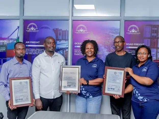 Ugandan business team holding their framed ISO certificates