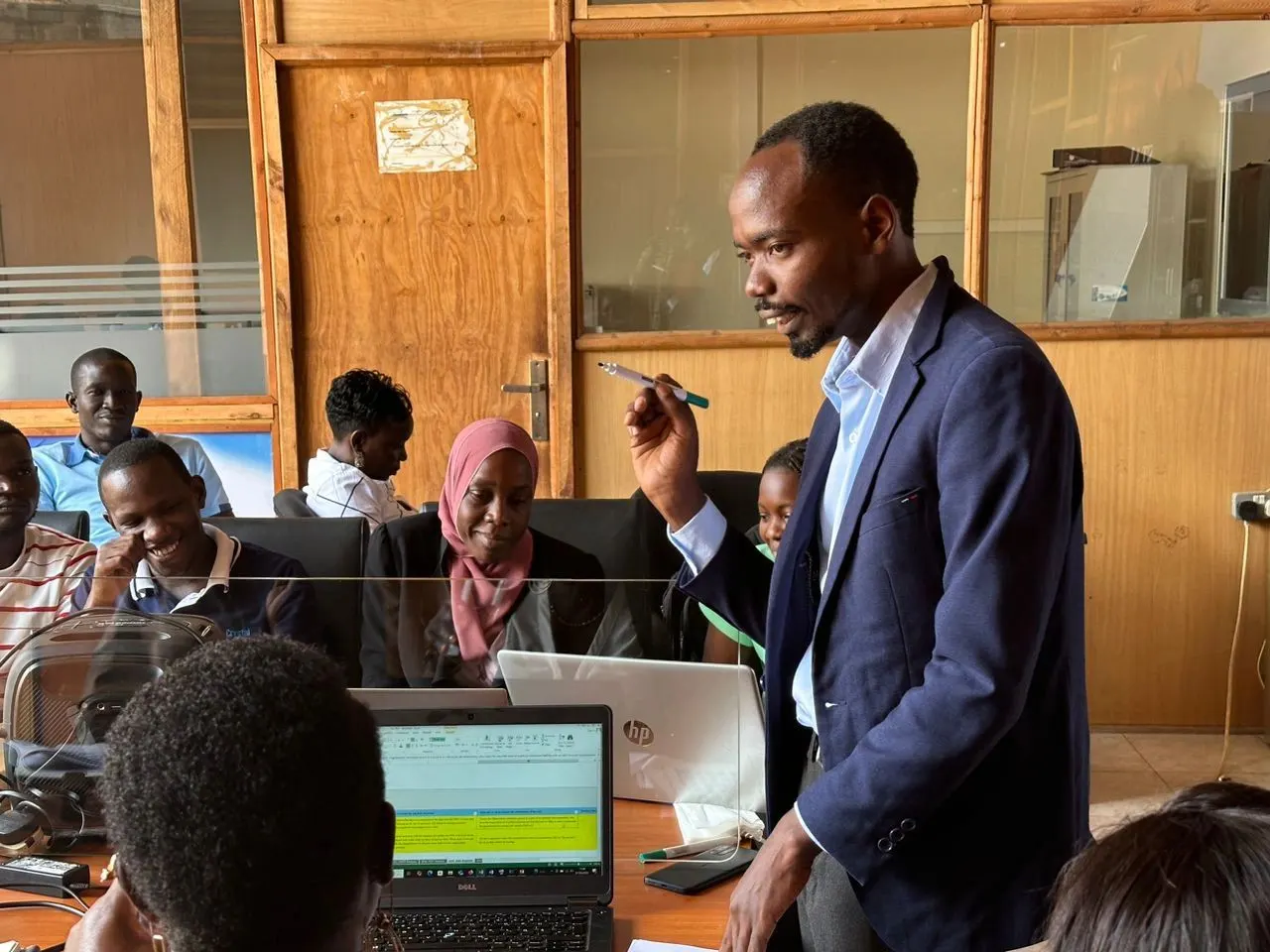 ISO Lead Auditor training session in Uganda with professionals at laptops